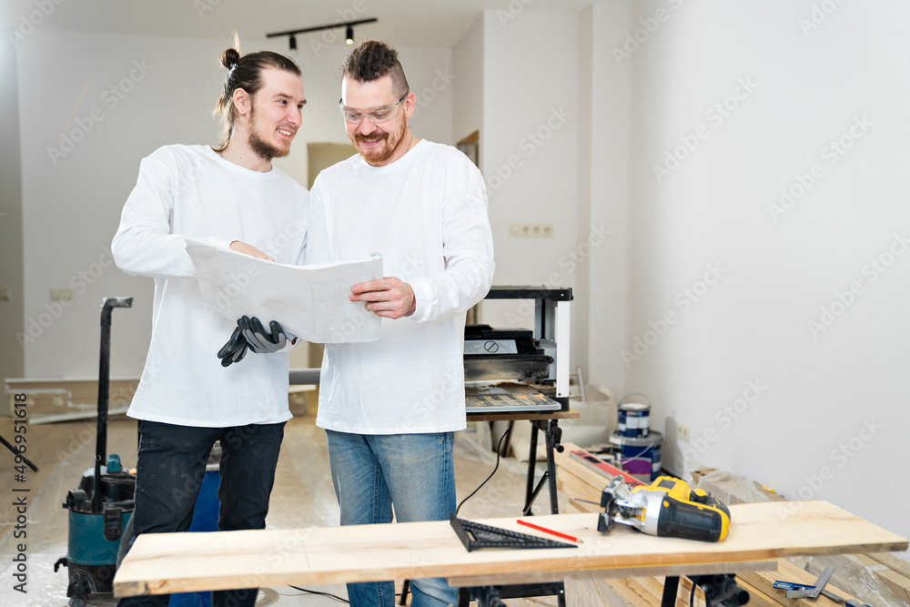 engineers with design project of furniture or apartment on construction site. engineers with design project of furniture or apartment on construction site.