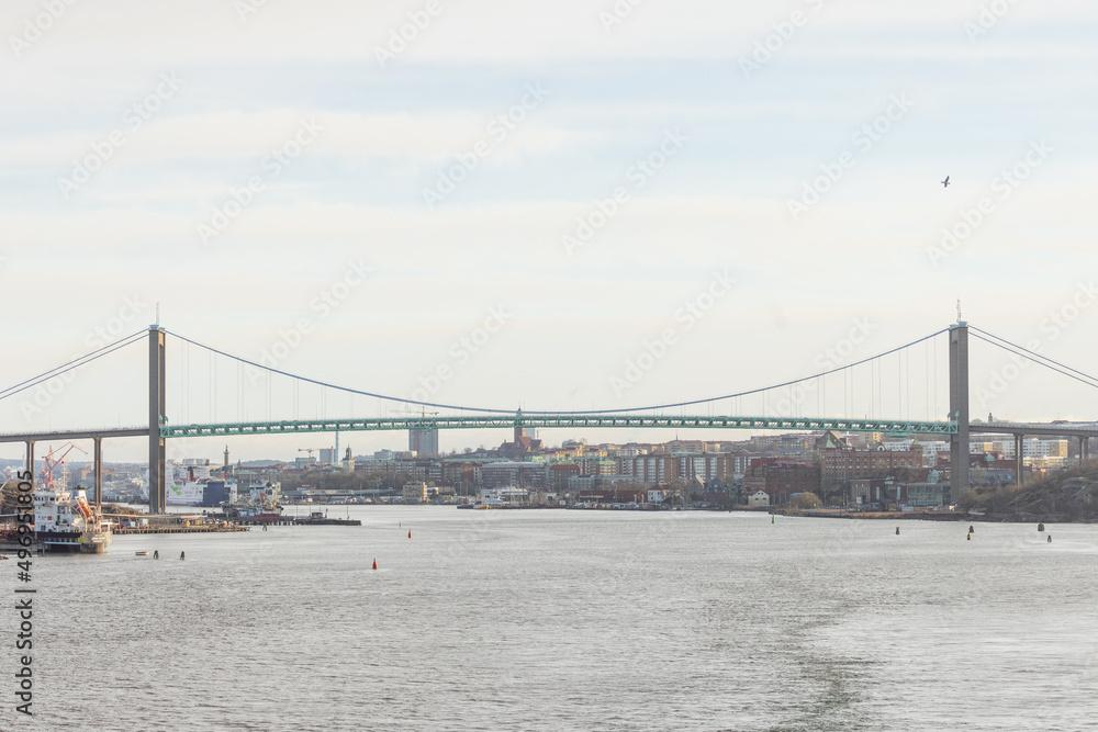 Naklejka premium View of magnificent Älvsborgsbron bridge in Gothenburg as viewed from the passing ship. Cloudy overcast day.