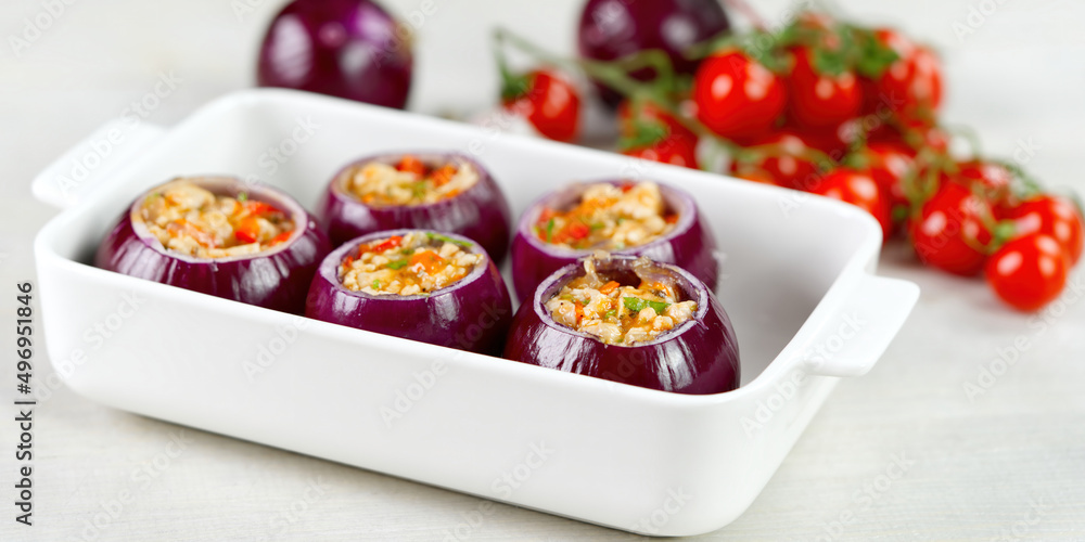 Stuffed onions recipe. Red onions stuffed with meat and vegetables in white bowl ready to bake in the oven. close up Stuffed onions recipe. Red onions stuffed with meat and vegetables in white bowl ready to bake in the oven. close up