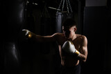 The bag athlete practices blows boxer The glove black young male body, from muscular muscle in fight for fist lifestyle, studio sweat. Backlit active box, one
