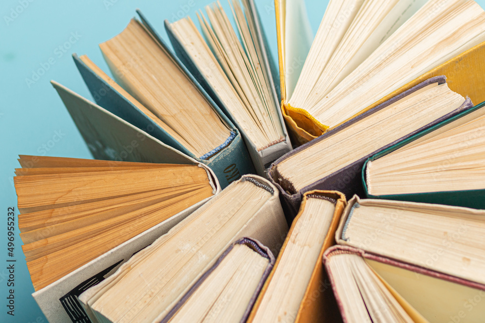 Fototapeta premium Old vintage books on blue background. World Book Day poster. Education concept