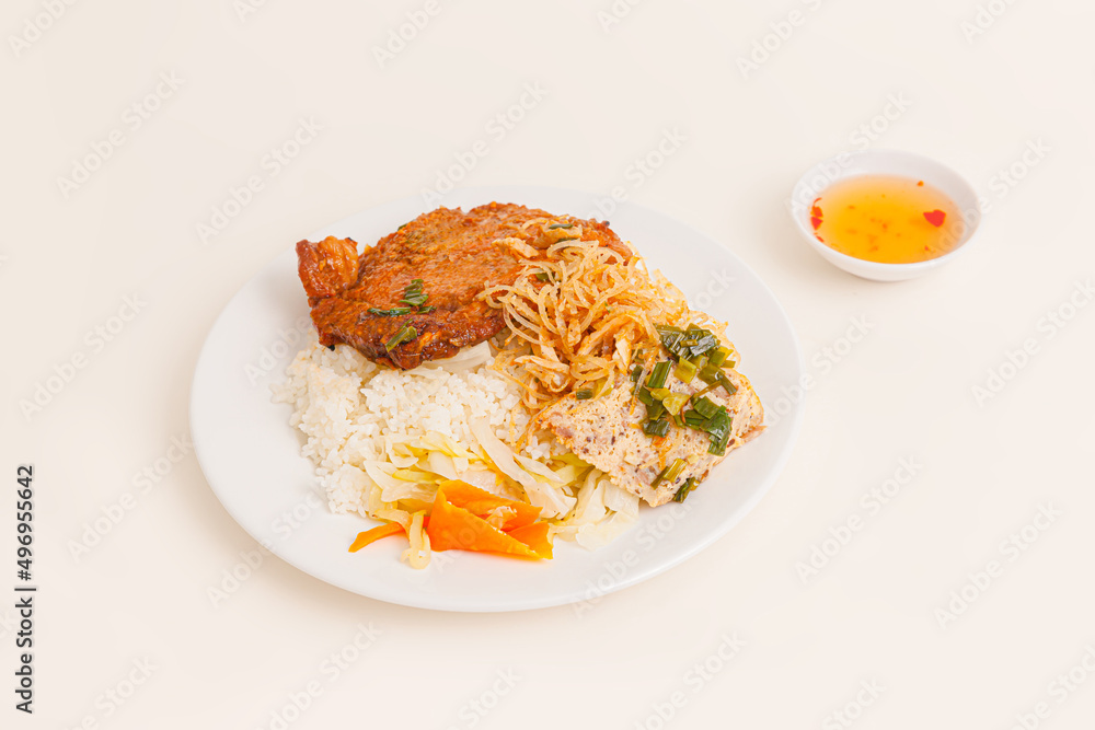 Com Tam. Broken Rice with grilled pork ribs, egg pie, fish sauce , Vietnamese food isolated on white background, perspective view Com Tam. Broken Rice with grilled pork ribs, egg pie, fish sauce , Vietnamese food isolated on white background, perspective view