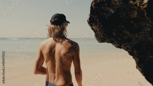 Man walking on a beach in Bali photo