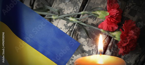 Burning candle and flag of ...
