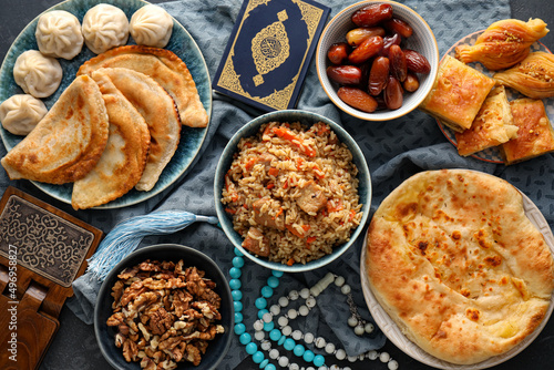 Traditional Eastern dishes with Quran on dark background