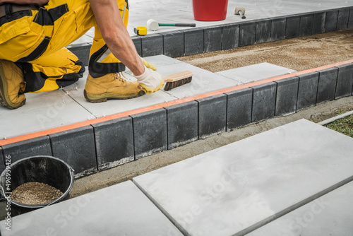 Backyard Garden Concrete Bricks Paving Performed by Professional Worker