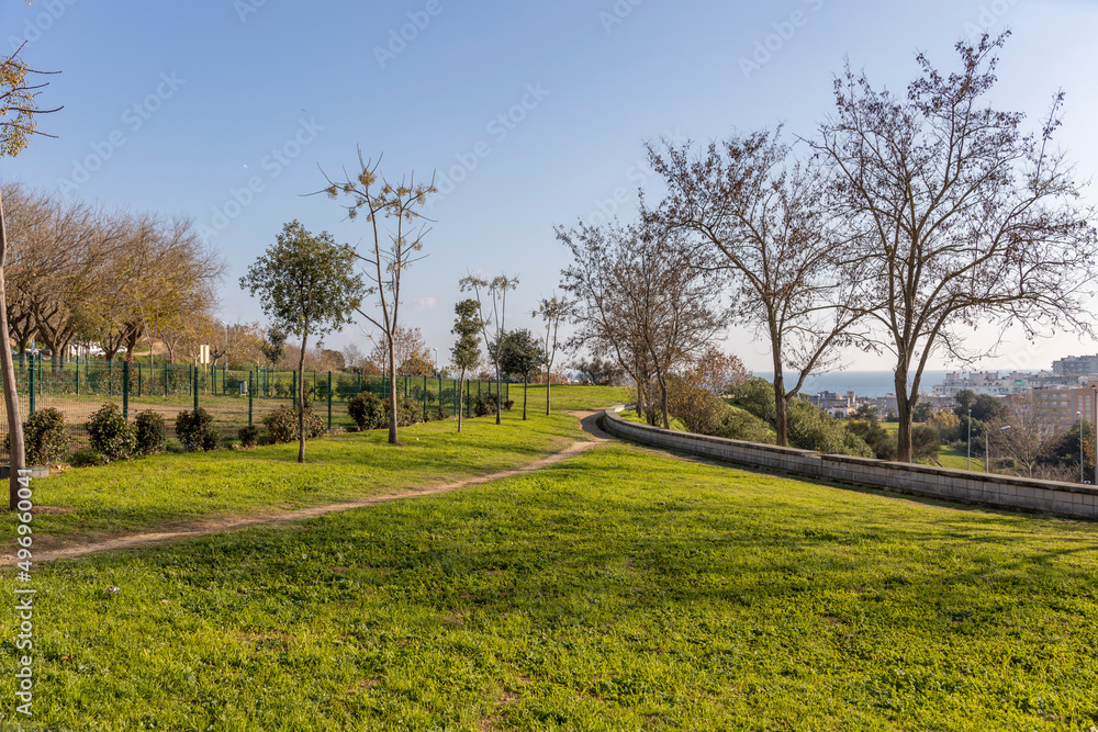Park in the center of the tourist city. Urban environment. Cityscape with a beautiful view. Bright greenery illuminated by the sun. Park in the center of the tourist city. Urban environment. Cityscape with a beautiful view. Bright greenery illuminated by the sun.