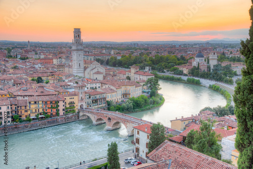 Sunset over Adige riverside in verona with church san giorgio in braide and cathedral santa maria matricolare photo