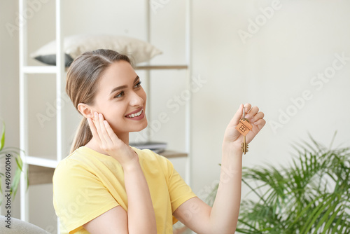 Happy young woman with key ...