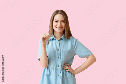 Smiling young woman with ke...