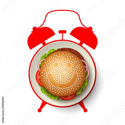Hamburger with smiling face made from sesame seeds, and alarm clock