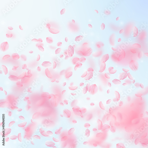 Sakura petals falling down. Romantic pink flowers gradient. Flying petals on blue sky square background. Love, romance concept. Resplendent wedding invitation.