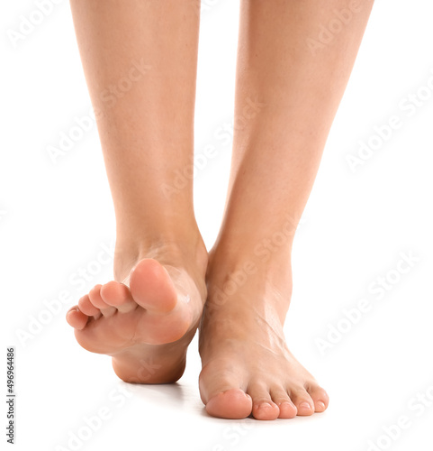 Female bare feet on white background, closeup
