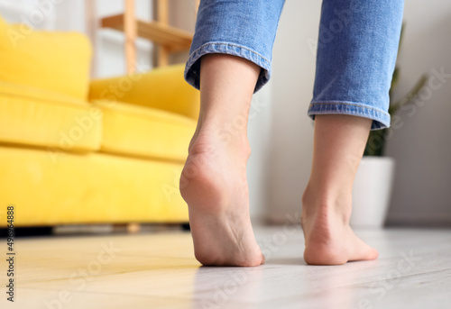 Woman with bare feet at home, closeup