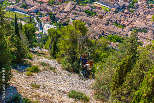 People are enjoying ride at Funivia Colle Eletto in Gubbio, Italy photo