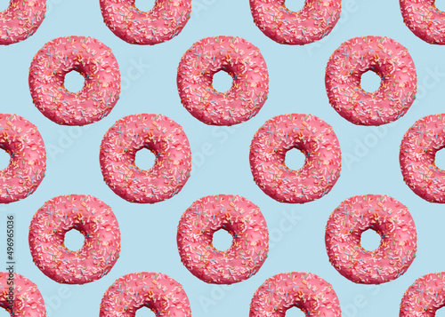 Donuts. Seamless pattern in pop art. Pink glazed doughnuts with icing on light blue backdrop