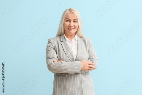 Mature secretary on blue ba...