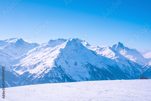 Scenic view of snow covered mountains. Ski tracks on white landscape. Idyllic view of alps during winter.