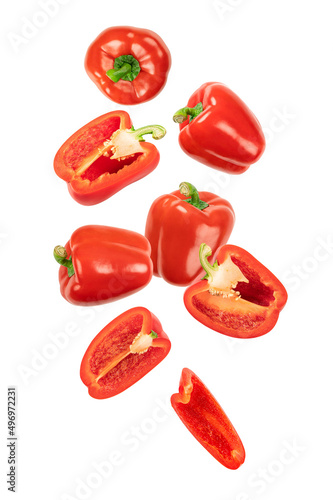 Falling red bell peppers isolated on white background.