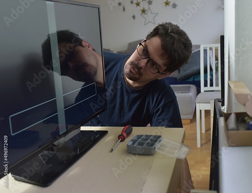 The man repairing broken tv at home