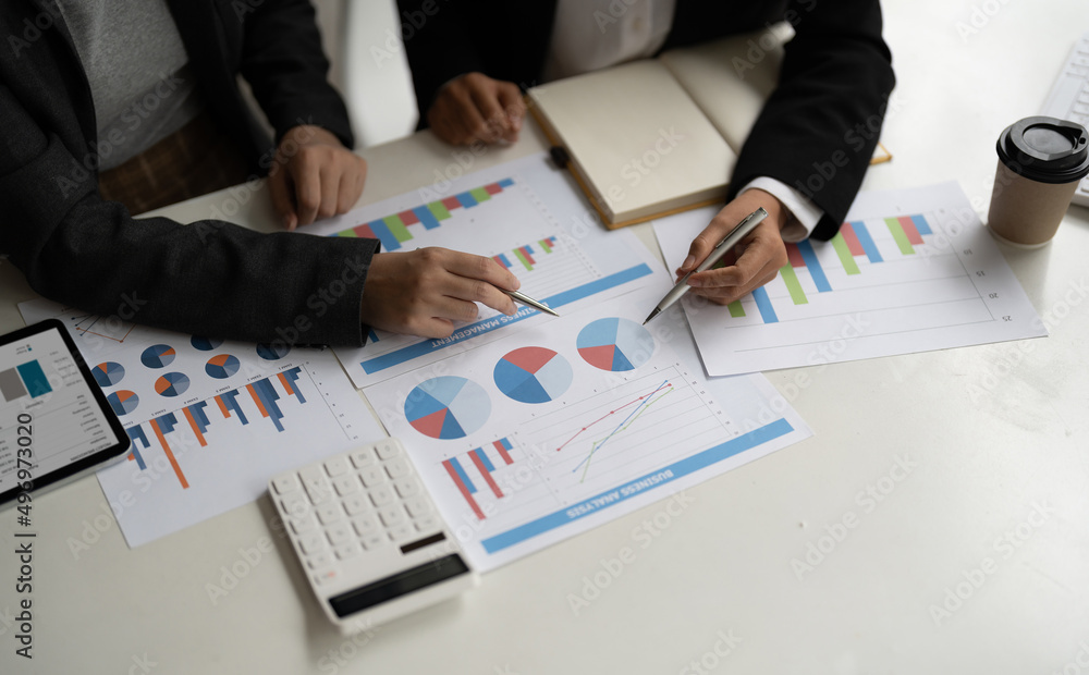 young business team meeting in the office talk about analyses chart graph marketing plan with computer laptop calculator young business team meeting in the office talk about analyses chart graph marketing plan with computer laptop calculator