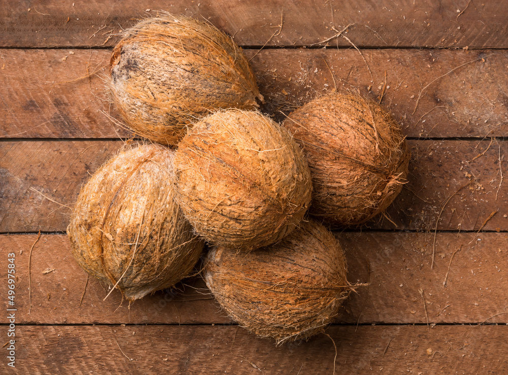 coconut, healthy tropical fruits without husk on a wooden table top, taken from coconut, healthy tropical fruits without husk on a wooden table top, taken from