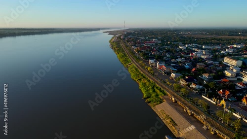 Aerial view over the town of Nakhon Phanom province beside the Mekong river as Thailand - 
Laos border in the morning with sunlight shiny photo