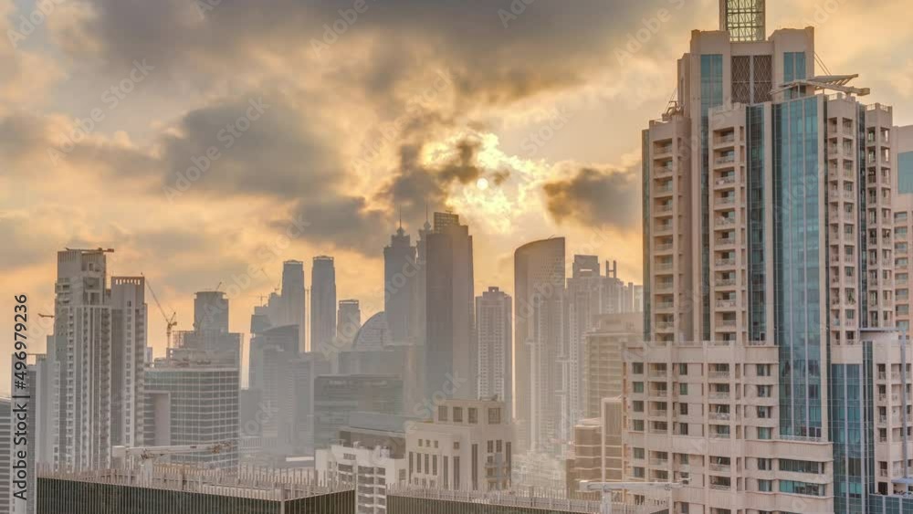 Dubai skyscrapers with golden sunset over business bay district timelapse. Dubai skyscrapers with golden sunset over business bay district timelapse.