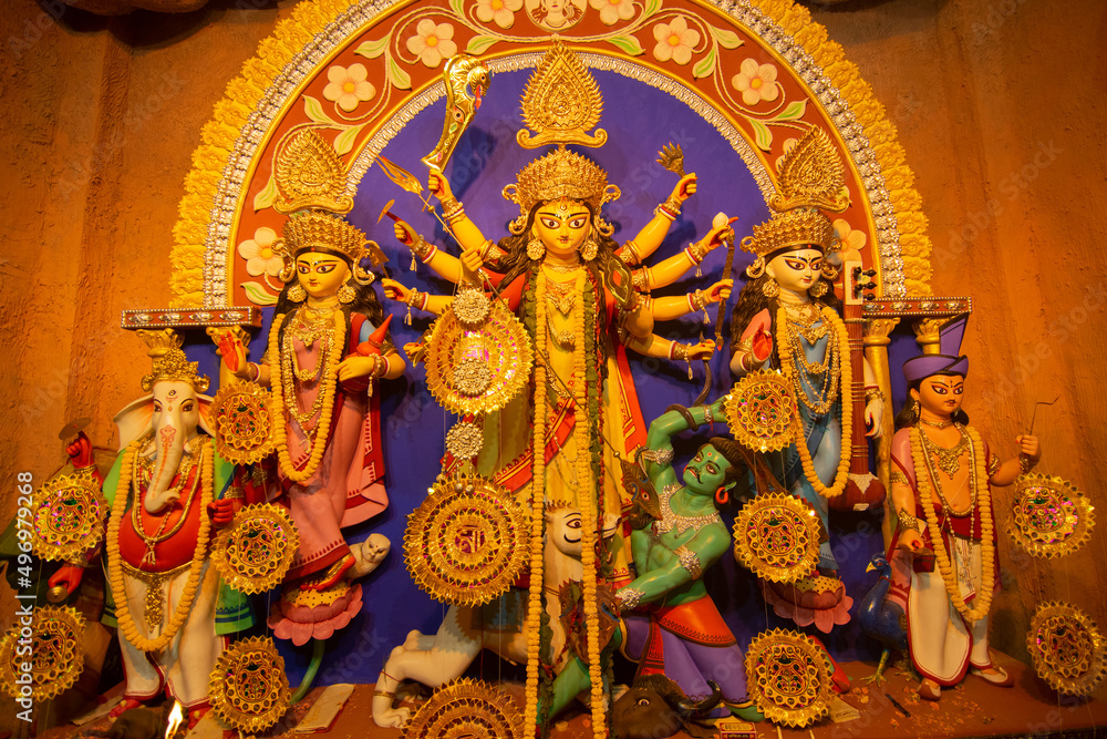 Kolkata , India - October 16, 2018 : Goddess Durga idol inside decorated Durga Puja pandal, shot at colored light . Durga Puja is biggest religious festival of Hinduism.