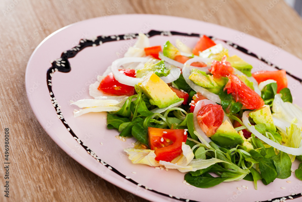 Image of salad of avocado, tomatoes, grapefruit and corn salad