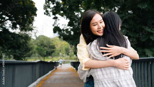 Two beautiful Asian women are hugging each other warmly, tightly to encourage and comfort. Sisters' hugs to cheer them up on days when they're feeling down.young women showing love to each other.