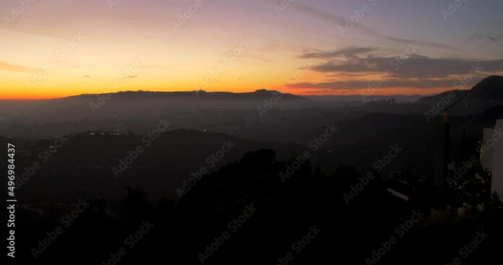 View of colorful sky at sunset from Griffith observatory, Los Angeles, USA. Beautiful hilly terrain under orange sky. 4K. View of colorful sky at sunset from Griffith observatory, Los Angeles, USA. Beautiful hilly terrain under orange sky. 4K.