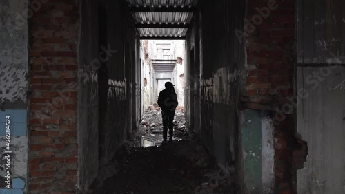 silhouette in an abandoned house. dark corridor in a ruined building. abandoned scary house 