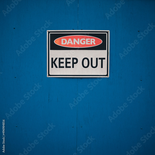 Danger sign on a blue wall
