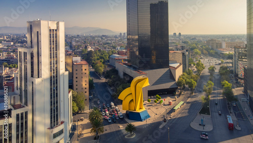 Caballito Tower in the town of Mexico City, reforma street and some buildings  photo