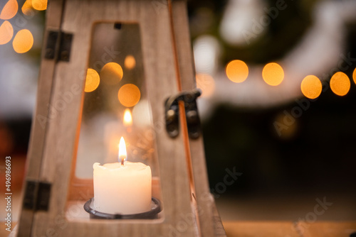 A candle burns closed inside a decorative lantern on Christmas Day.