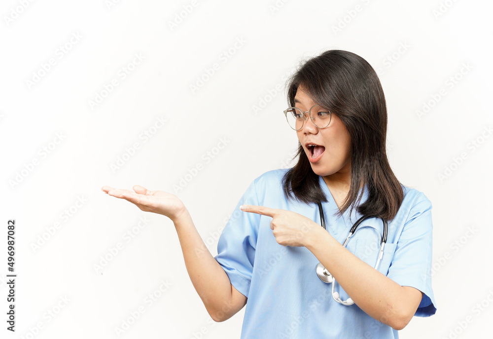 Showing and Pointing Product With Thumb Of Asian Young Doctor Isolated On White Background Showing and Pointing Product With Thumb Of Asian Young Doctor Isolated On White Background