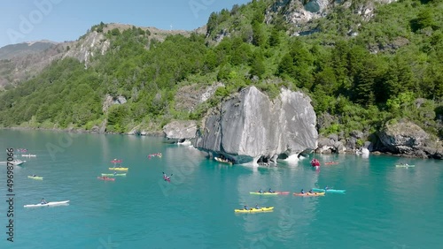 Kayakers Exploring Marble Chapel Caves On Lake General Carrera. Aerial Circle Dolly