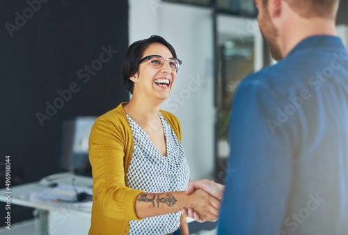 Happy at the opportunity to work together. Cropped shot of businesspeople shaking hands in an office.