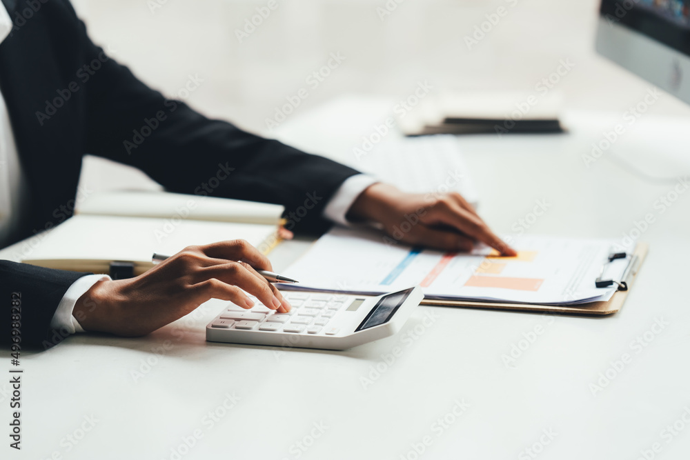 Financial inspector calculating a numbers in office room. Financial inspector calculating a numbers in office room.