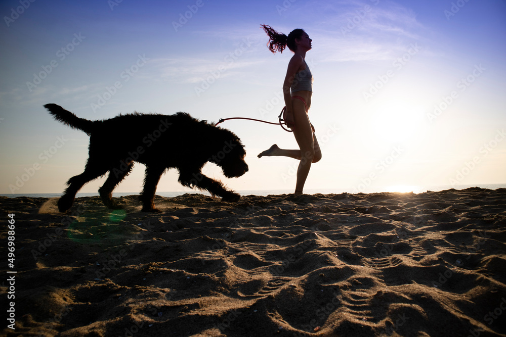 Girl running in the company of her dog Girl running in the company of her dog