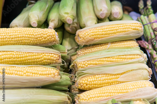 Pile of fresh sweet corn on farmers market