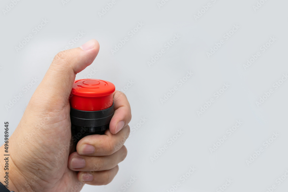 Stop Red Button and the Hand of Worker About to Press it. emergency stop button. Big Red emergency button or stop button for manual pressing. Stop Red Button and the Hand of Worker About to Press it. emergency stop button. Big Red emergency button or stop button for manual pressing.