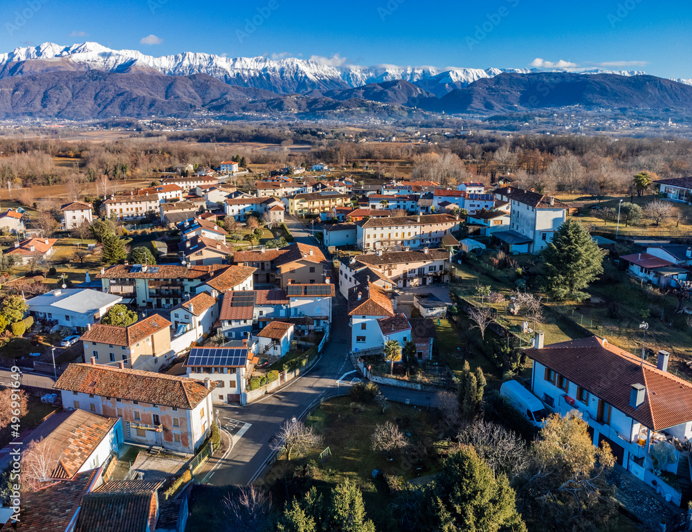 Central Friuli villages seen from above. Between hills and snow-capped mountains. Martinazzo of Cassacco.