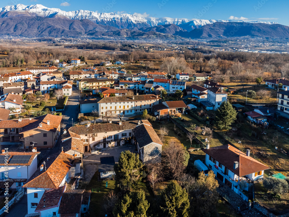 Central Friuli villages seen from above. Between hills and snow-capped mountains. Martinazzo of Cassacco.