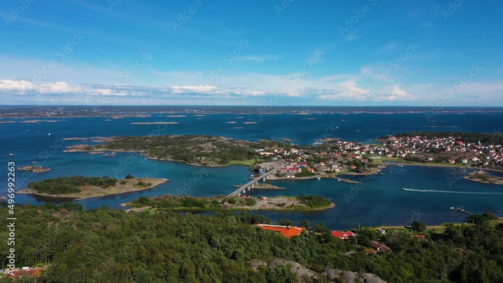 Donso Island From Above With Boat Cruising In The Calm Blue Sea In Sweden. - aerial Donso Island From Above With Boat Cruising In The Calm Blue Sea In Sweden. - aerial