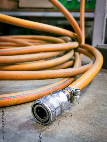 Close up photo yellow hose with compressor coupler.