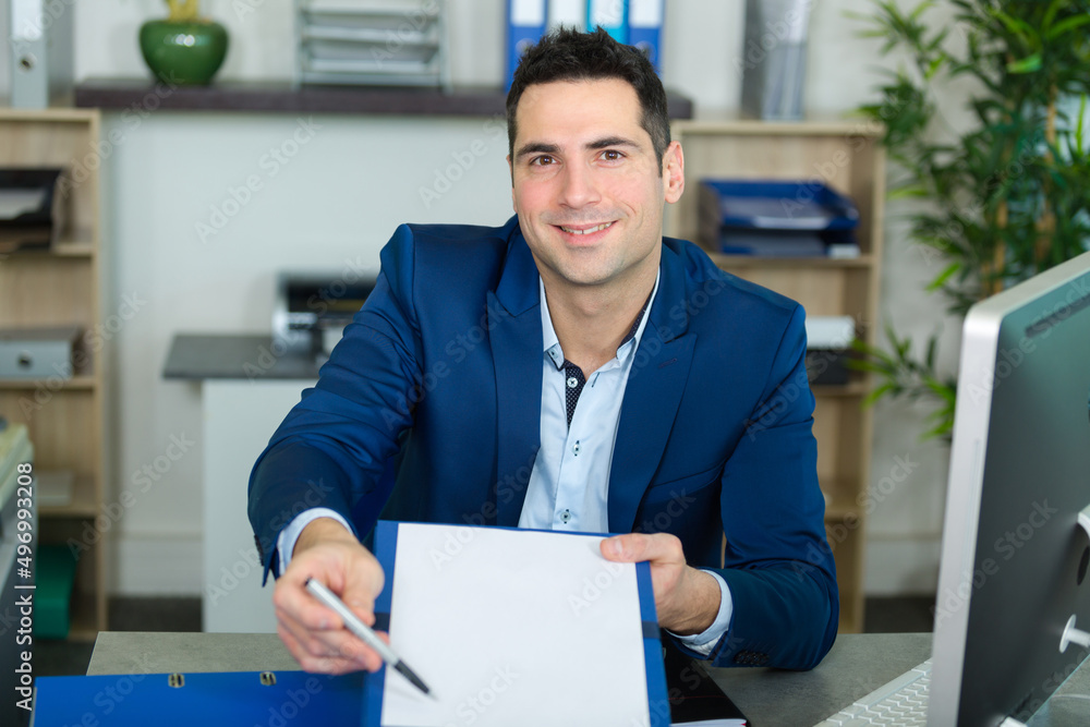 man asking for signature in an office man asking for signature in an office