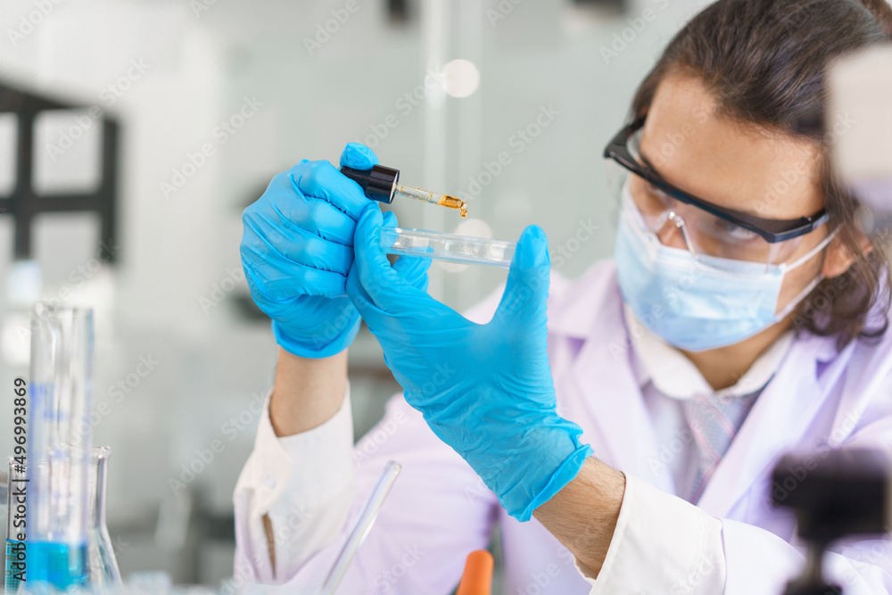 Laboratory research concept, Scientist drop of solution into petri dish for research of drug Laboratory research concept, Scientist drop of solution into petri dish for research of drug
