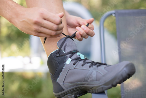 hiking shoes - woman tying shoe laces